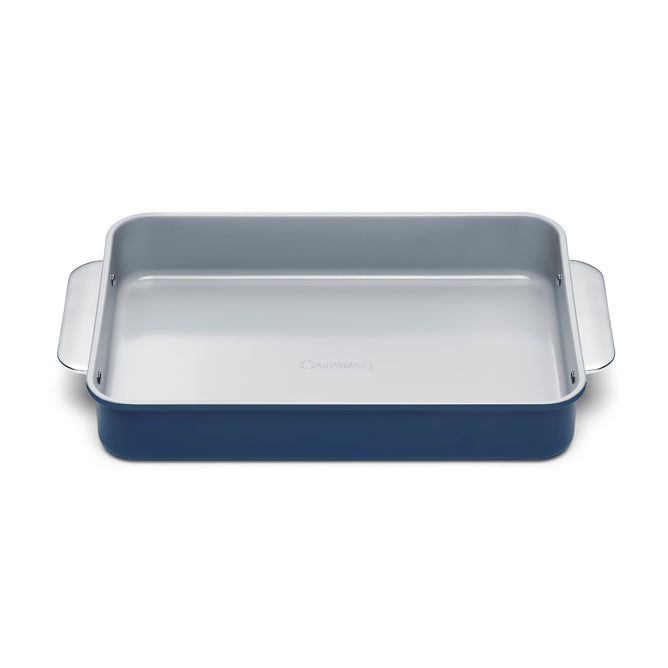 The Caraway Ceramic Rectangle Baking Pan features a blue exterior, light gray interior, and non-toxic ceramic coating. Its side handles and smooth, flat base make it ideal for healthy baking.