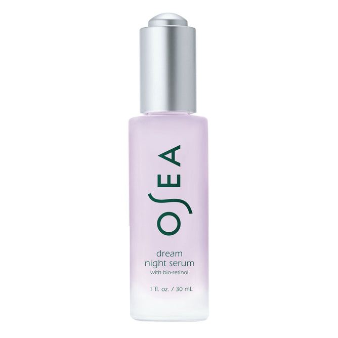 The OSEA Dream Night Serum, a 1 fl. oz. (30 mL) clear bottle with a stylish silver cap, contains bio-retinol and firming peptides in a light purple tint for transformative overnight care.