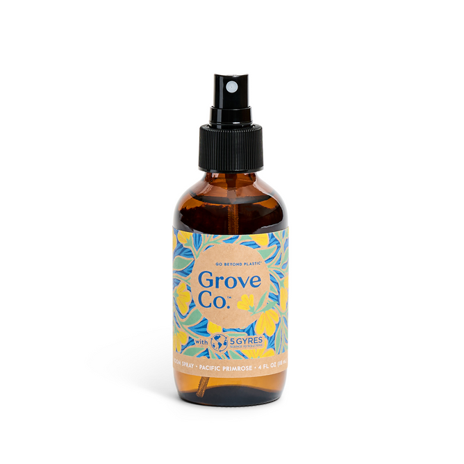 The limited edition Grove Co. Room Spray from the spring collection features a brown glass bottle with a black nozzle, a blue and yellow floral label stating Grove Co. and 60% Recycled Plastic, and is available in Pacific Primrose scent, 4 fl oz (118 ml).