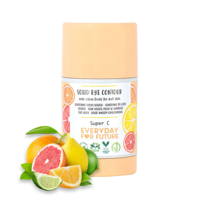 The Solid Eye Contour Serum Stick by Everyday For Future is a cylindrical solid with a vibrant label of oranges, lemons, and grapefruits, highlighting its Vitamin C-rich formula. Fresh citrus nearby complements the lively design, emphasizing its natural ingredients.
