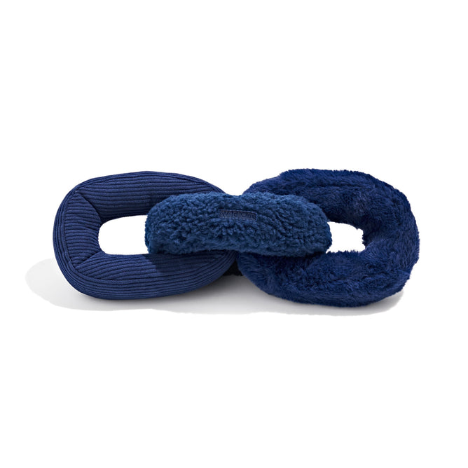 The Wild One Plush Chew Chain Dog Toy features two interlocked, donut-shaped toys in dark blue—one with a corduroy texture and the other with a fluffy, fleece finish. These squeaky toys are designed for pets to chew and play with, providing endless fun.