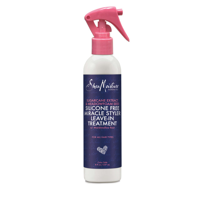 A SheaMoisture Silicone Free Miracle Styler Leave-In Treatment bottle with a pink spray nozzle, featuring a dark blue label highlighting sugarcane and meadowfoam seed oil alongside marshmallow root for all hair types. Contains 8 fl oz / 236 ml.