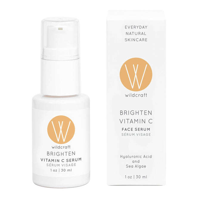 A sleek white bottle and box of Wildcraft Brighten Vitamin C Face Serum feature a pump dispenser and logo, showcasing its formula with hyaluronic acid and sea algae for radiant skin.