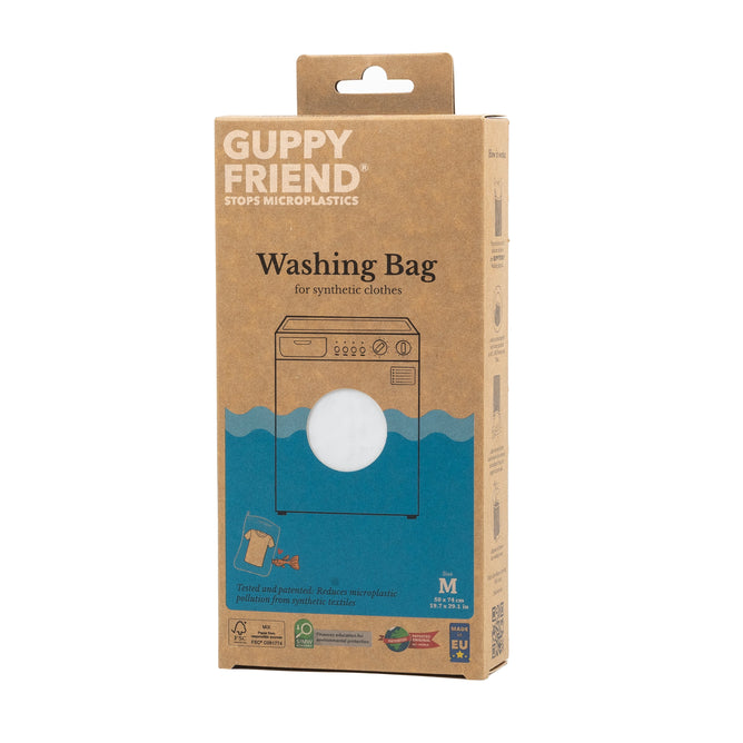 The image shows a cardboard box of the GUPPYFRIEND Washing Bag, Prevent Microplastic Pollution. It underscores its role in fighting microplastic pollution with eco-friendly symbols and clear labeling that stress its sustainability dedication.